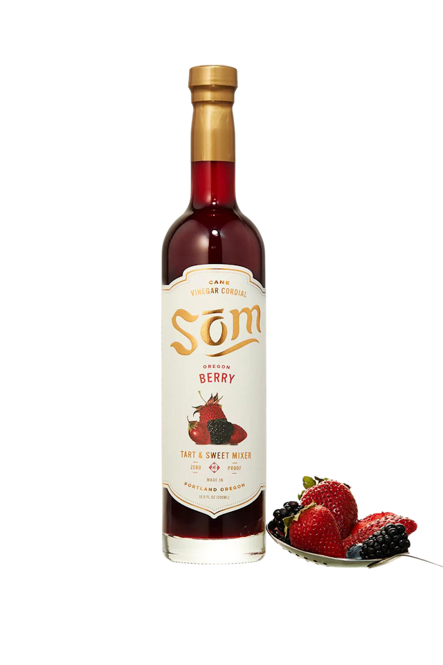 Bottle of non-alcoholic drink Oregon Berry by Som Cordial and spoon with berries